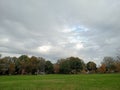 Empty park on autumn in a rainy day with overcast sky Royalty Free Stock Photo