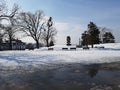 Empty park in Belgrade fortress castle hill benches siting winter snow cold white blue sky clear melting trees serbia Royalty Free Stock Photo