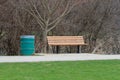 An empty park bench in a city park. Royalty Free Stock Photo