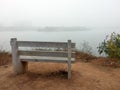Empty park bench on the edge of a lake Royalty Free Stock Photo