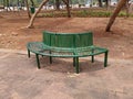 Empty Park bench under a canopy of eucalyptus trees. Royalty Free Stock Photo