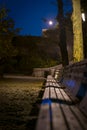 Empty park benches on a quiet Autumn night, at Carl Schurz Park, New York City