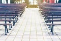 Empty park benches rows in front of an open air stage. Bulgaria, Bourgas, Sea Garden. Royalty Free Stock Photo