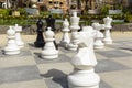 Empty park with big chess figures and empty chairs on background.Nobody playing in games. Royalty Free Stock Photo