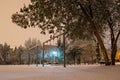 Empty park swings during a Winter night, after a few snow heavy hours. Quiet outdoor place in Bucharest, Romania Royalty Free Stock Photo