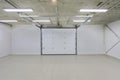 Empty parking garage, warehouse interior with large white gates and gray tile floor