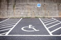 Empty parking lot with disabled parking sign on road. Royalty Free Stock Photo