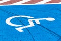 Empty parking spot for the handicapped, blue wheelchair symbol on the ground. Parking place for the disabled indicator Royalty Free Stock Photo