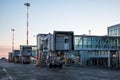 Empty passenger boarding bridges at the early morning airport apron