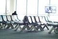 Empty passenger waiting seats in lounge after check-in next to air plane gate Royalty Free Stock Photo