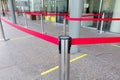 Empty paths bounded by a red ribbon. Tape security at the airport