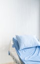 Empty patient`s bed scene with white wooden paint background in natural light scene / hospital and insurance concept / ward room Royalty Free Stock Photo