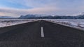 Empty paved ring road in the south of Iceland near Skaftafell with the snow-covered foothills of ÃârÃÂ¦fajÃÂ¶kull. Royalty Free Stock Photo