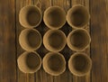 Empty peat pots for seedlings on an old wooden vintage table. Top view.