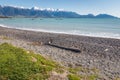 Empty pebble beach in Kaikoura with Kaikoura Seaward Ranges in distance, New Zealand