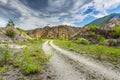 Empty rural road through rugged terrain