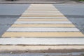 Empty pedestrian crossing in street - white and yellow colors