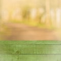 Empty perspective green wood over blurred trees with bokeh background, for product display montage Royalty Free Stock Photo