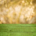 Empty perspective green wood over blurred trees with bokeh background, for product display montage Royalty Free Stock Photo