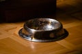 Empty pet food bowl left dirty after cat or dog has eaten Royalty Free Stock Photo