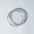 Empty petri dish with hard shadow on a white table Royalty Free Stock Photo