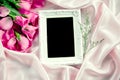 the Empty photo frame with a bouquet sweet pink roses petal on Royalty Free Stock Photo