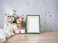 Empty photo frame candles artificial pink rose on bike toy on wood table, cement texture background, gray color ,copy space for le Royalty Free Stock Photo