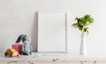 Empty photo frame mockup on white marble table with rabbit doll houseplant plant and wooden toy car. Art and interior home Royalty Free Stock Photo