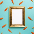 Empty photo frame with orange gerbera daisy flower petals on blue background Royalty Free Stock Photo