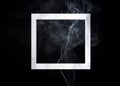 Empty photo frame with smoke on black background. Dark surreal concept with picture frame layout. Trendy minimal template with