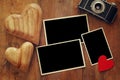 empty photo frames next to old camera and hearts Royalty Free Stock Photo