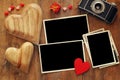 empty photo frames next to old camera and hearts Royalty Free Stock Photo