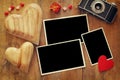 empty photo frames next to old camera and hearts Royalty Free Stock Photo