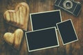 empty photo frames next to old camera and hearts Royalty Free Stock Photo