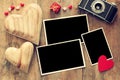 empty photo frames next to old camera and hearts Royalty Free Stock Photo