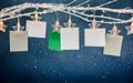 Empty photo frames or notes hanging on bare twig with glowing star clothespins