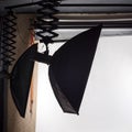 Empty photo studio with lighting equipment and white paper background ready for photoshoot. Royalty Free Stock Photo