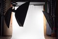 Empty photo studio with lighting equipment and white paper background ready for photoshoot. Royalty Free Stock Photo