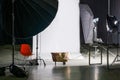 Empty photo studio with modern interior and lighting equipment. Preparation for studio shooting: empty chair and studio lighting.