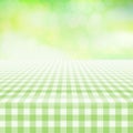 Empty picnic gingham tablecloth, green background