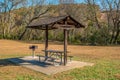 Picnic table and grill in a park Royalty Free Stock Photo