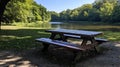 Empty picnic table by river in park Royalty Free Stock Photo