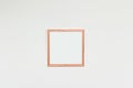 Empty picture frame with blank space for photo or art on a white interior wall Royalty Free Stock Photo