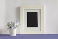 Empty picture frame, decorated with blue flowers Royalty Free Stock Photo