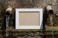 Empty Picture Frame Near Old Weathered Water Fountain