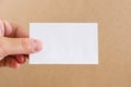 Empty piece of paper in a female hand. White card in a hand. Close-up. Copy space. Place for text. Royalty Free Stock Photo