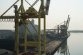 Empty pier of coal terminal in port of Venezia, Italy with some cargo gantry cranes, pile of black coal.