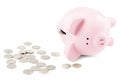 Empty piggy bank and coins on white background Royalty Free Stock Photo