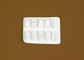 Empty pill packets. top view isolated empty white medicine package on brown background Royalty Free Stock Photo