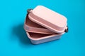 Empty pink bento lunch box on blue background Royalty Free Stock Photo